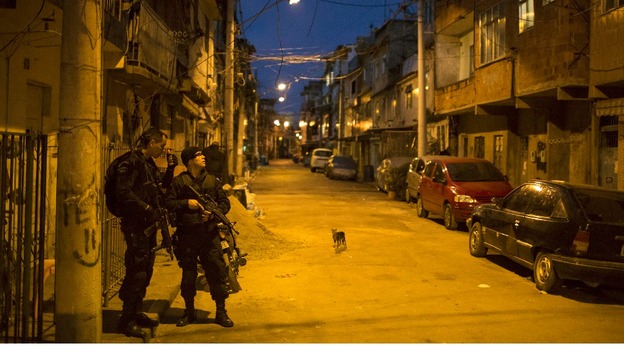Special operations battalion police officers take position during an operation to occupy part of the Mare slum complex.