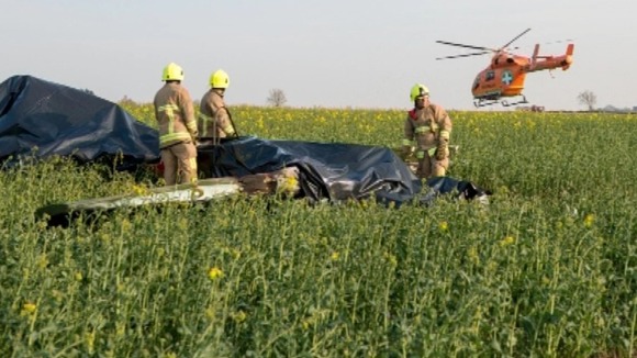 Firefighters with wreckage.