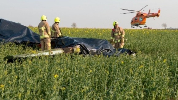 Firefighters with wreckage.