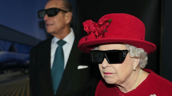 The Queen and the Duke of Edinburgh wearing 3D glasses to watch a display during a visit to the University of Sheffield