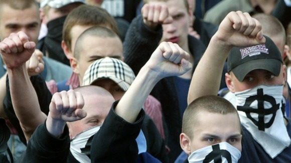 Masked Ukrainain nationalists shout racist slogans during a May day demonstration in 2006.
