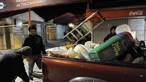 Residents take their belongings to higher ground after a Tsunami alarm at Talcahuano city, south of Santiago on the southern Pacific coast.