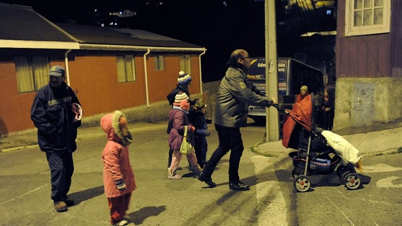 Residents take their belongings to higher ground after a Tsunami alarm at Talcahuano city, south of Santiago on the southern Pacific coast.