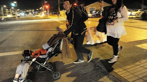 Residents take their belongings to higher ground after a Tsunami alarm at Talcahuano city, south of Santiago on the southern Pacific coast.