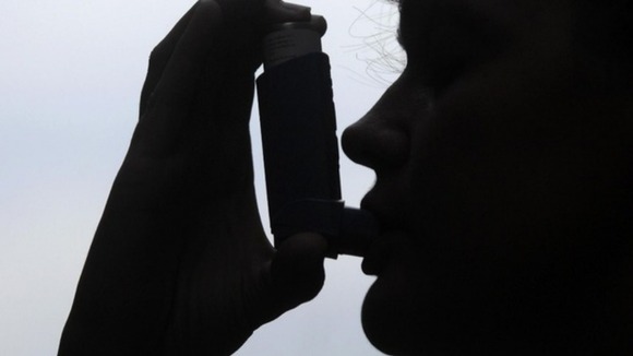 File photo of a woman taking a puff on an inhaler.