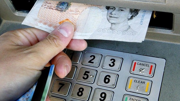 Money being withdrawn from an ATM.