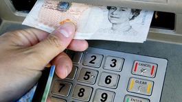 Money being withdrawn from an ATM.