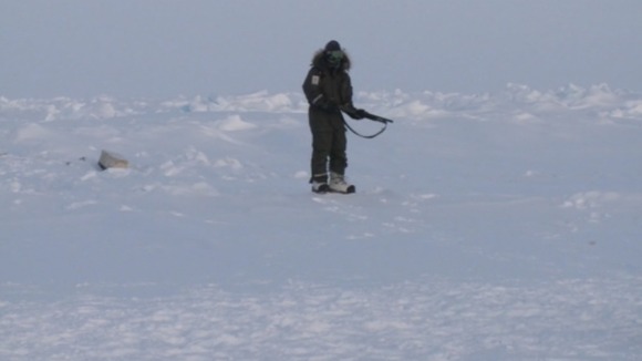 A polar bear guard stands watch over the course.