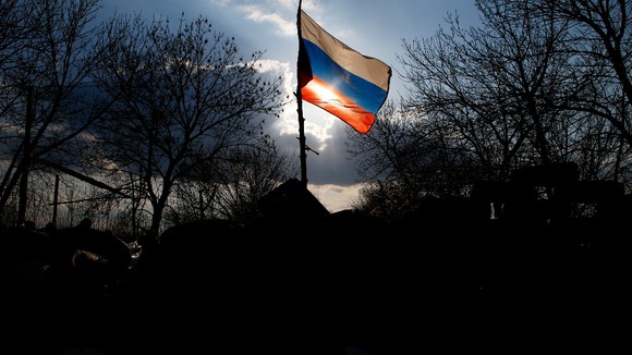 A Russian flag flutters on a barricade in front of Kramatorsk airbase in eastern Ukraine.