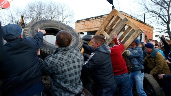 Pro-Russia separatists build a barricade in front of a Ukrainian airbase in Kramatorsk.