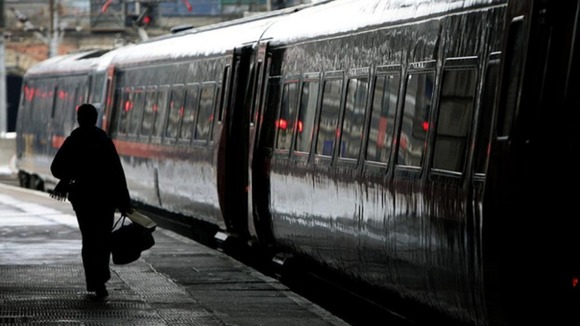 Passenger walks alongside train at platform