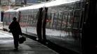 Passenger walks alongside train at platform