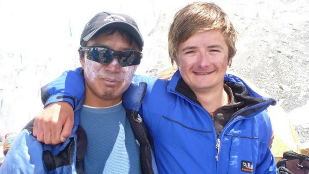 Matthew (right) with one of the team who helped him on the climb.