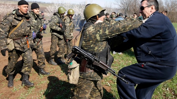 A Ukrainian soldier clashes with a pro-Russia separatist in the field near Kramatorsk, eastern Ukraine.