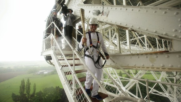 Comedian John Bishop with the torch on the Lovell telescope