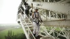 Comedian John Bishop with the torch on the Lovell telescope