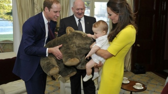 Prince George, with his parents, receives a gift from the Governor-General.