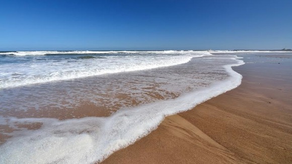 sea rolling onto Warkworth beach