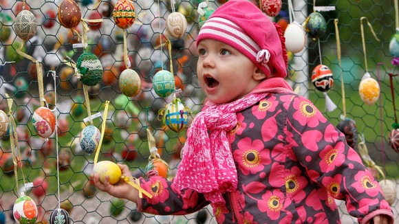 A girl walks past an installation made of Easter eggs in Kiev.
