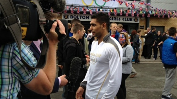 Amir Khan preparing to carry torch in Bolton