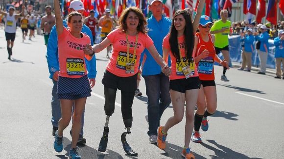 Celeste Corcoran (C) and her daughter Sydney (R) finish the race with Celeste's sister Carmen Acabbo.
