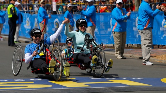 Patrick Downes (L) and Jessica Kensky cross the finish line