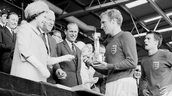 England captain Bobby Moore holding the Jules Rimet Trophy, he collected from the Queen