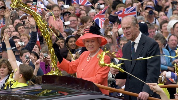 The Queen and the Duke of Edinburgh, ride along The Mall in an open-top car