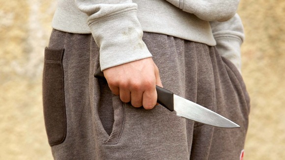 A young man with a knife.
