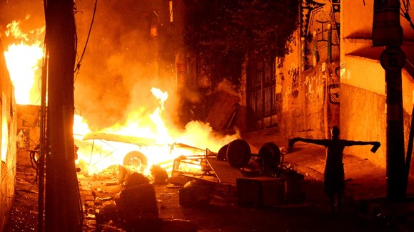 Fires burn in the streets as people react angrily to the death of a man in Pavao-Pavaozinho slum, in the Copacabana neighborhood