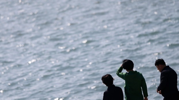 Relatives of passengers of the Sewol ferry look out to sea