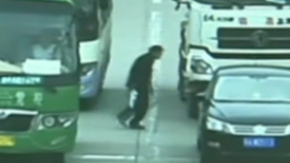 The man seconds before he passes in front of the lorry