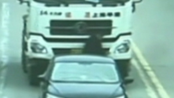 The man just before he disappears under the truck
