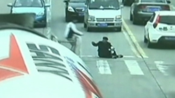 A student comes to help the man who has been hit by a lorry