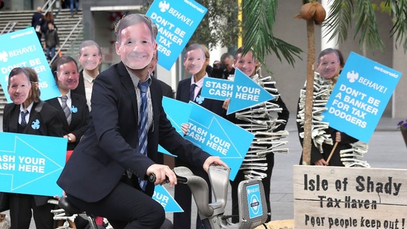 Demonstrators wearing the face of Barclays boss Antony Jenkins outside the bank's annual general meeting