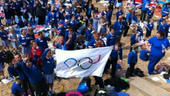 Children greet the torch in Crosby