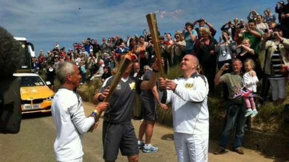 And the Olympic flame is passed on