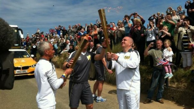 And the Olympic flame is passed on