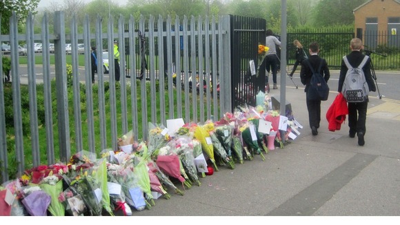 Flowers line the fence of Corpus Christi Catholic College in Leeds.