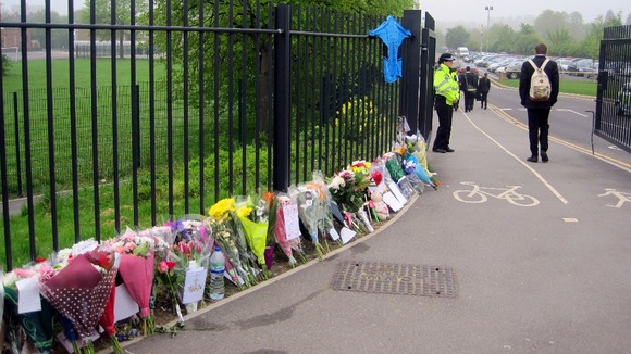Flowers line the fence of Corpus Christi Catholic College in Leeds.