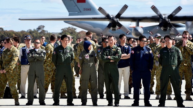 International aircrews involved in the search for missing flight MH370 prepare for official photograph.