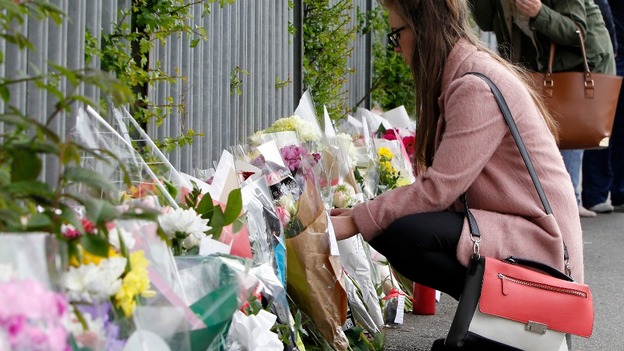 Flowers are left outside Corpus Christi Catholic College in Leeds following the much-loved teacher's death.