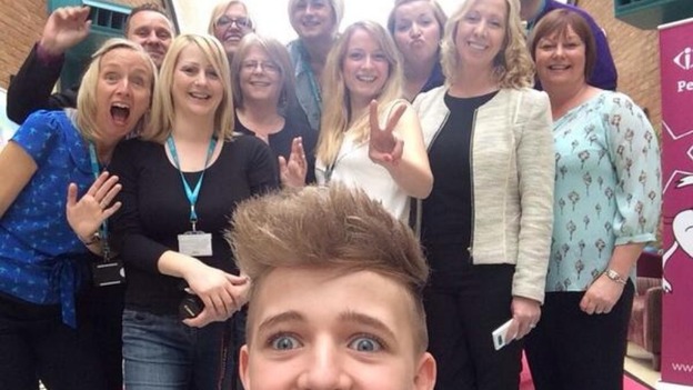 The MK College staff pose for a photograph with Bailey.