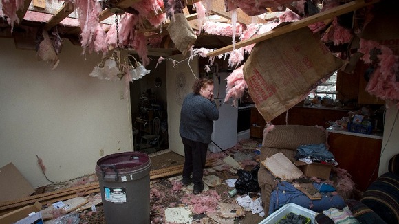Theresa Long inside her destroyed house in Mayflower, Arkansas.