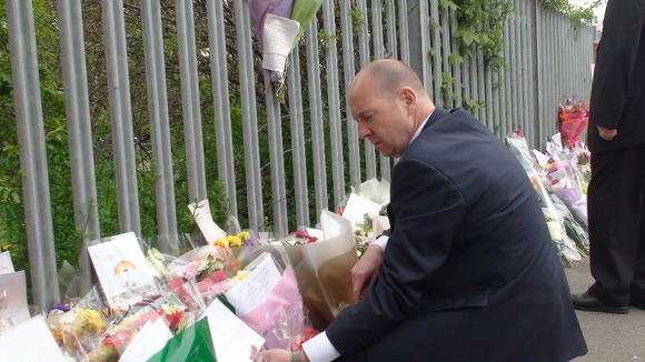 Headteacher Steve Mort with flowers left for Ann Maguire.