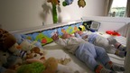 2 babies in a cot