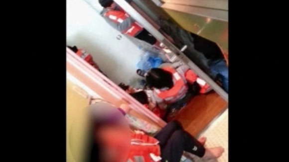 Students eventually put on life jackets and some are seen lying on the floor.