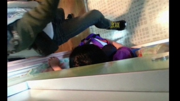 A student lunges to stay upright on the tilting ship.
