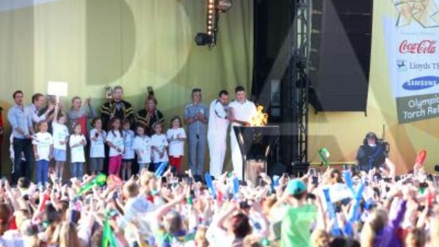 Craig Lundberg on stage with Olympic torch