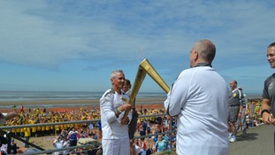 Man and small boy holding torch